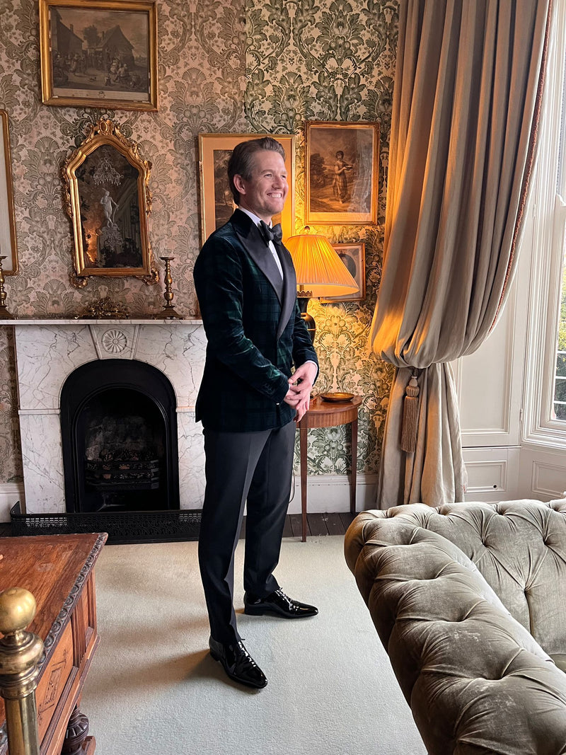 Arnoud in a velvet tuxedo in a panelled drawing room